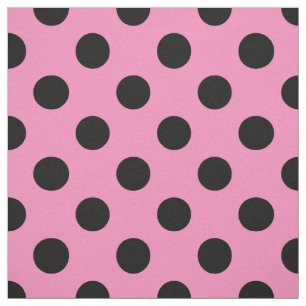 Black polka dots on pink fabric