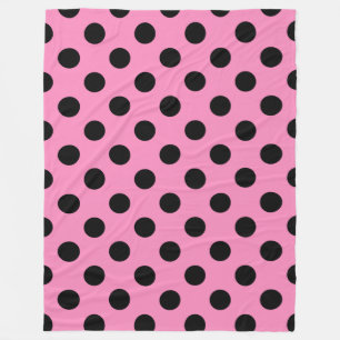 Black polka dots on pink fleece blanket