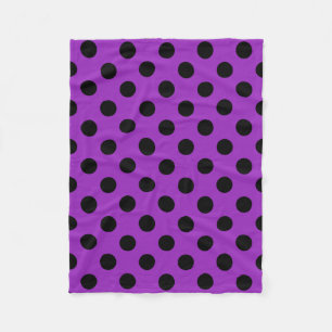 Black polka dots on purple fleece blanket
