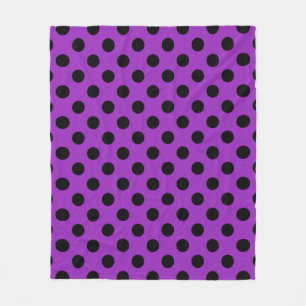 Black polka dots on purple fleece blanket