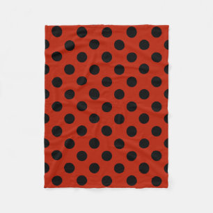 Black polka dots on red fleece blanket