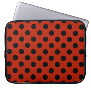 Black polka dots on red laptop sleeve