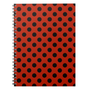 Black polka dots on red notebook