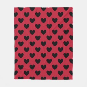 Black polka hearts on red fleece blanket