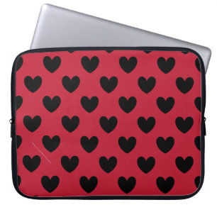 Black polka hearts on red laptop sleeve