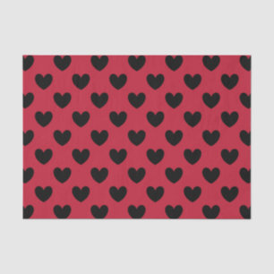 Black polka hearts on red tissue paper