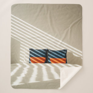 Black red and white plaid textile on white bed sherpa blanket