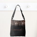 Black rose gold glitter monogram script crossbody bag<br><div class="desc">A chic black background decorated with rose gold glitter drops. Personalize and add a name. Rose gold coloured text. The name is written with a modern hand lettered style script with swashes. To keep the swashes only delete the sample name, leave the spaces or emoji's in front and after the...</div>