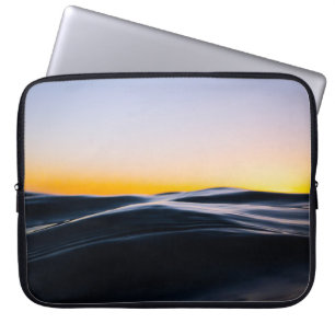 BLACK SAND UNDER ORANGE SKY DURING SUNSET LAPTOP SLEEVE