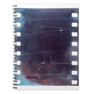 black scratched 35mm film frame, emulsion texture notebook