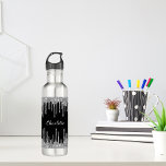 Black silver glitter drips custom monogram name 710 ml water bottle<br><div class="desc">A stylish black background with elegant faux silver glitter drips,  paint dripping look. Personalize and add your name. The name is written with a white hand lettered style script.</div>