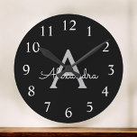 Black Silver Modern Script Girly Monogram Name Round Clock<br><div class="desc">Black and Silver Simple Script Monogram Name Clock. This makes the perfect sweet 16 birthday,  wedding,  bridal shower,  anniversary,  baby shower or bachelorette party gift for someone that loves glam luxury and chic styles.</div>