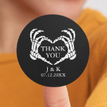 Black Skeleton Heart Til Death Wedding Thank You Classic Round Sticker<br><div class="desc">Black wedding thank you stickers from the collection "'Til death do us part". It features spooky skeleton hands forming a heart on the front. Party supplies with an editable date and the bride and groom's initials or names. Be sure to visit our collection to see more coordinating items that match...</div>