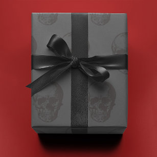 Skulls crowns and faded red roses on a dark black wrapping paper