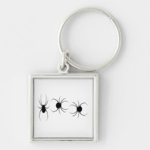 Black spiders on white keychain
