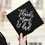 Black | Thanks Mom and Dad Graduation Cap Topper<br><div class="desc">Thank your parents for their support by wearing a custom graduation cap topper in their honour. The stylish graduation cap topper features "Thanks Mom and Dad" in a trendy modern script font against a black background.</div>