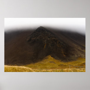 Black volcanic mountain and low clouds poster