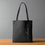 Black White Modern Minimalist Elegant Monogram Tote Bag<br><div class="desc">Introducing our Black and White Minimalist Modern Monogram Collection: Embrace simplicity and sophistication with our minimalist designs, curated to elevate your style effortlessly. Crafted with a keen eye for modern aesthetics, this collection features sleek black and white designs accentuated by personalized monograms. From chic stationery to versatile accessories, our collection...</div>