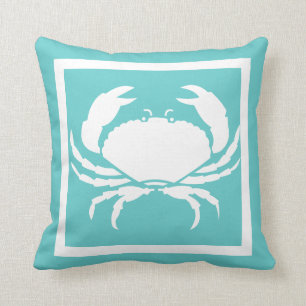 BLANC de CRABE sur le coussin bleu turquoise