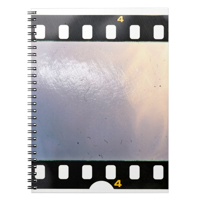 Blank 35mm film frame or strip on white background notebook (Front)