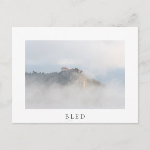 Bled castle surrounded by clouds postcard