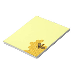 Bloc-notes avec abeille à miel sur un peigne de mi