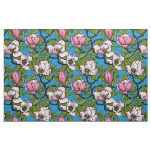 Blooming magnolia on blue fabric