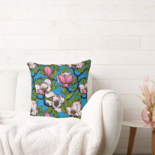 Blooming magnolia on blue throw pillow