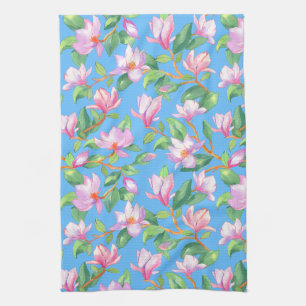 Blooming magnolia on sky blue kitchen towel