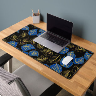 Blue and gold broad leaves pattern on black desk mat