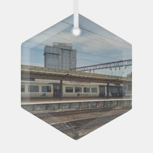 Blue and white train , in front of a building glass ornament