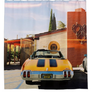 Blue car parked beside brown concrete building in
