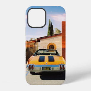 Blue car parked beside brown concrete building in iPhone 12 case