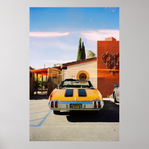 Blue car parked beside brown concrete building in  poster
