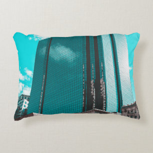 BLUE CURTAIN WALL BUILDING UNDER TEAL SKIES ACCENT PILLOW