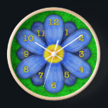Blue Daisy Flower on Green Beautiful Wall Clock<br><div class="desc">This pretty floral clock has an original stylized flower on it, in a daisy style and coloured blue. The yellow-orange clock numbers mark the time on the twelve petals. The background is done in an abstract mottled green, resembling grass. This is a bright, bold clock for a gardener or any...</div>