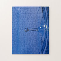 Blue drop of water in motion on a jigsaw puzzle