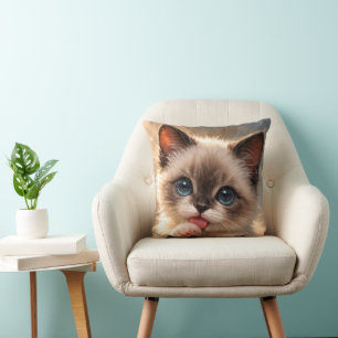 Blue-Eyed siamese,   Kitten licking its Paw Throw Pillow