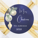 Blue gold white baubles Christmas Classic Round Sticker<br><div class="desc">For a Christmas party favours or gift wrapping. An navy blue uneven coloured background. Decorated with white and gold baubles and some greenery and a pine cone.  Personalize and add your name,  year.  Text: Merry Christmas</div>