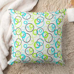 blue green and black rings and circles on white throw pillow