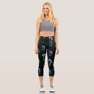 Blue green neon flowers on black capri leggings
