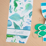 Blue green sea ocean fish dolphins white monogram beach towel<br><div class="desc">Under the sea, ocean theme. A chic white background with a watercolored pattern of marine life, fish, dolphins, a whale, turtle, seahorse, jellyfish in green, blue and teal. Perfect for a beach house or summer home. Personalize and add your name. The name is written with a blue green hand lettered...</div>