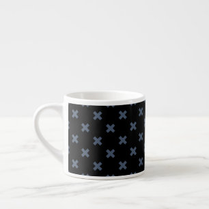 Blue-grey cross stitches on black espresso cup