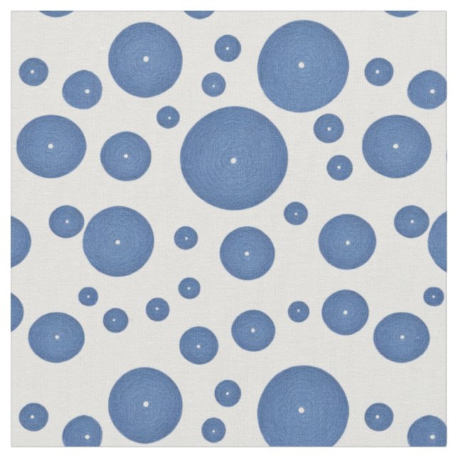 Blue knitted circles on a white background fabric (Close Up)