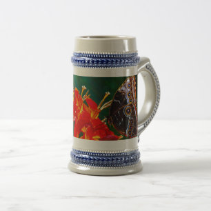 Blue morpho butterfly on Crocosmia Lucifer flowers Beer Stein