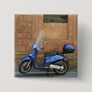 Blue motor scooter by red wall, Siena, Italy 2 Inch Square Button