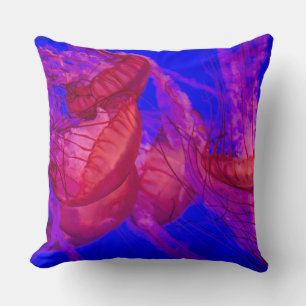 Blue ocean red jellyfish throw pillow