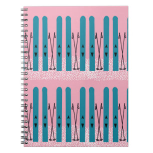 Blue skis on pink notebook