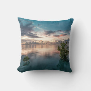 blue sky with red and dark clouds reflected on sea throw pillow