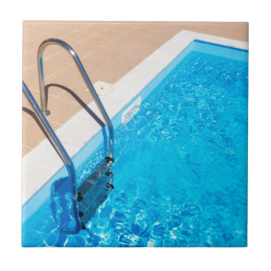 Blue swimming pool with ladder tile